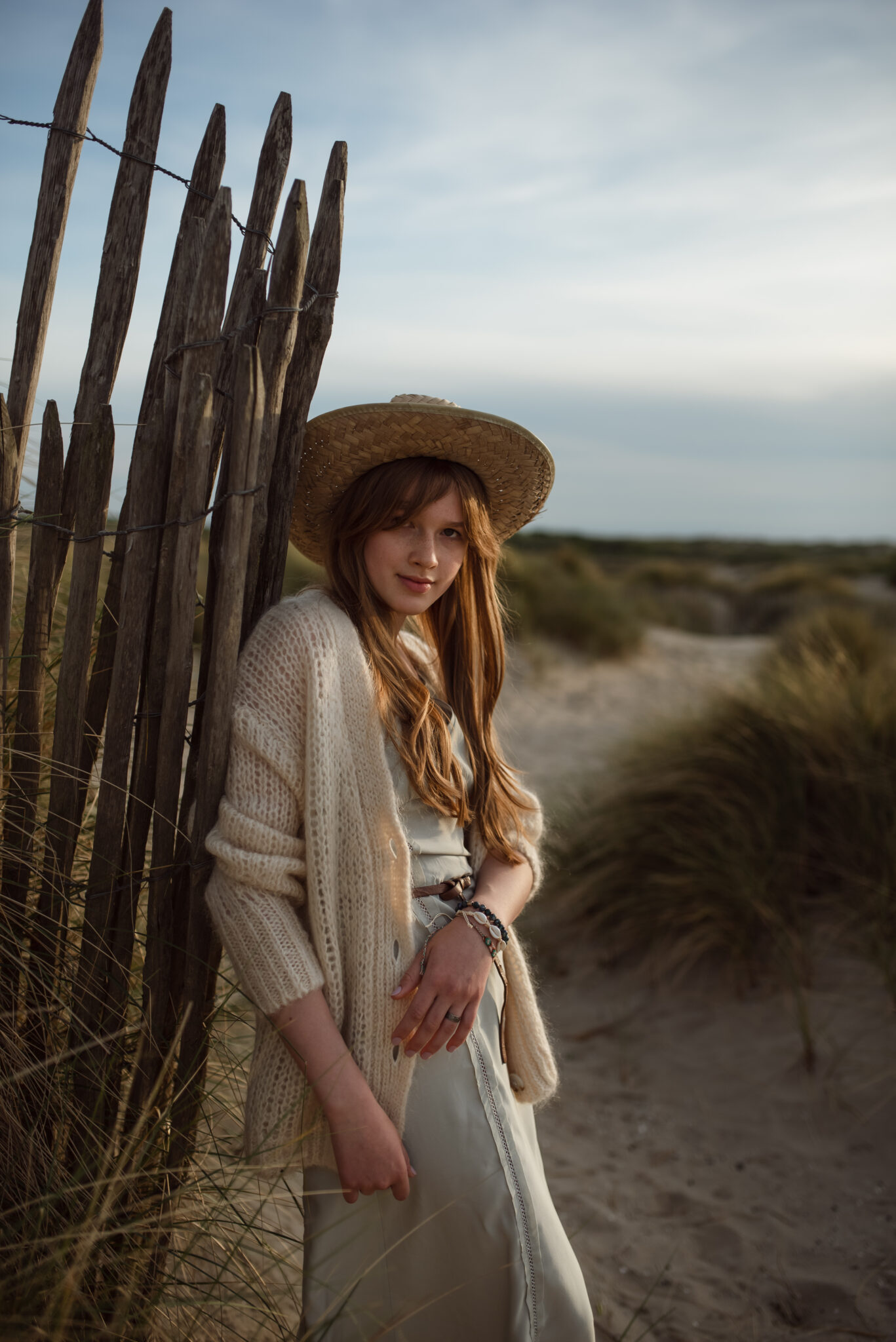 Boho style, teenage girl with a hat on a beach