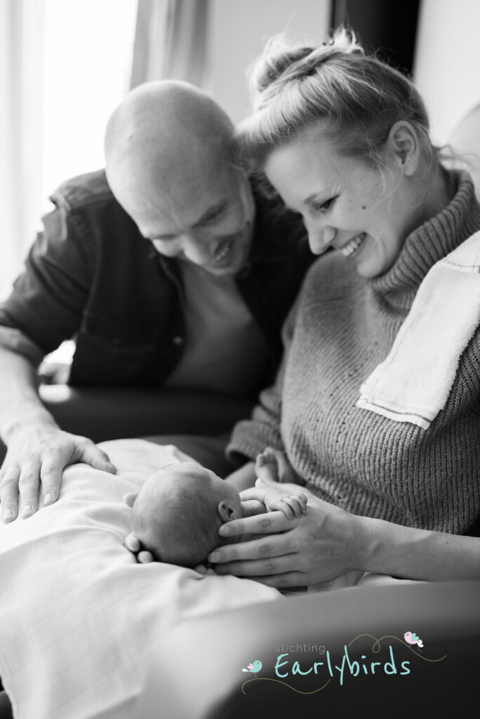 Parents smiling happy with premature newborn